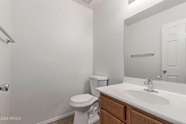 bathroom featuring tile patterned flooring, vanity, and toilet