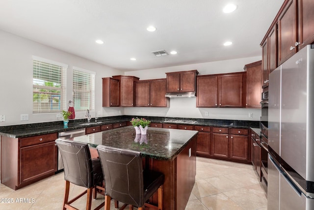 1876 E Azalea Ct, Gilbert, AZ 85298 - kitchen featuring appliances with stainless steel finishes, a center island, recessed lighting, dark stone countertops, and a sink