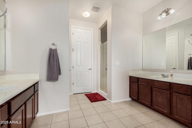 1876 E Azalea Ct, Gilbert, AZ 85298 - full bath with baseboards, a shower stall, two vanities, and tile patterned floors