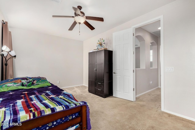 1876 E Azalea Ct, Gilbert, AZ 85298 - bedroom featuring arched walkways, light colored carpet, baseboards, and a ceiling fan