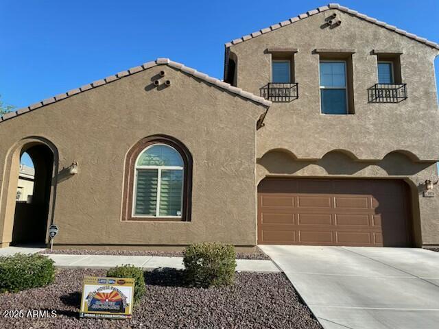 1876 E Azalea Ct, Gilbert, AZ 85298 - mediterranean / spanish-style home with stucco siding, concrete driveway, and a garage