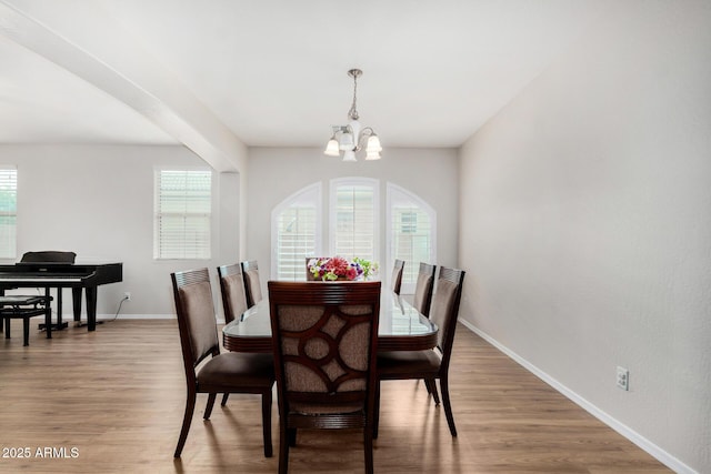1876 E Azalea Ct, Gilbert, AZ 85298 - dining room with healthy amount of natural light, baseboards, light wood-style floors, and a chandelier