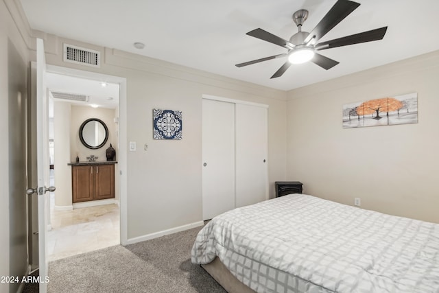 carpeted bedroom with ceiling fan and a closet