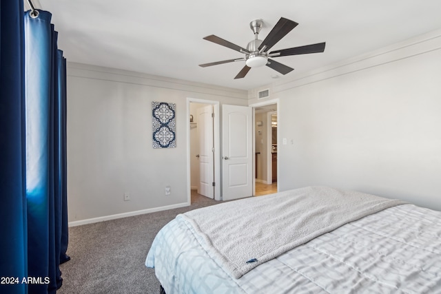 bedroom with dark colored carpet, ceiling fan, and crown molding