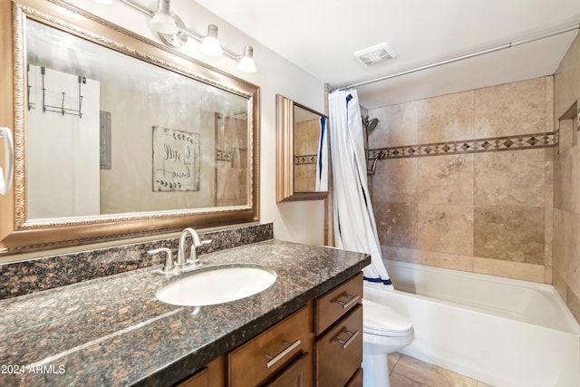 full bathroom featuring shower / tub combo with curtain, vanity, toilet, and tile patterned floors