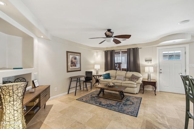 living room with ceiling fan and a healthy amount of sunlight