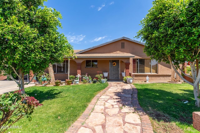 2207 N 53rd Ave, Phoenix, AZ 85035 - view of front facade featuring brick siding, a front lawn, and a porch