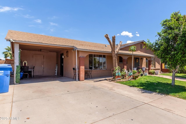 2207 N 53rd Ave, Phoenix, AZ 85035 - ranch-style house with a porch, driveway, a front yard, and an attached carport