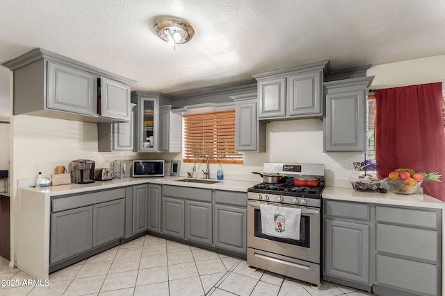 2207 N 53rd Ave, Phoenix, AZ 85035 - kitchen with a sink, appliances with stainless steel finishes, plenty of natural light, and gray cabinets