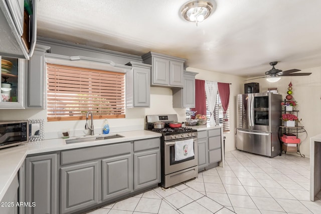 2207 N 53rd Ave, Phoenix, AZ 85035 - kitchen with gray cabinetry, appliances with stainless steel finishes, a ceiling fan, and a sink