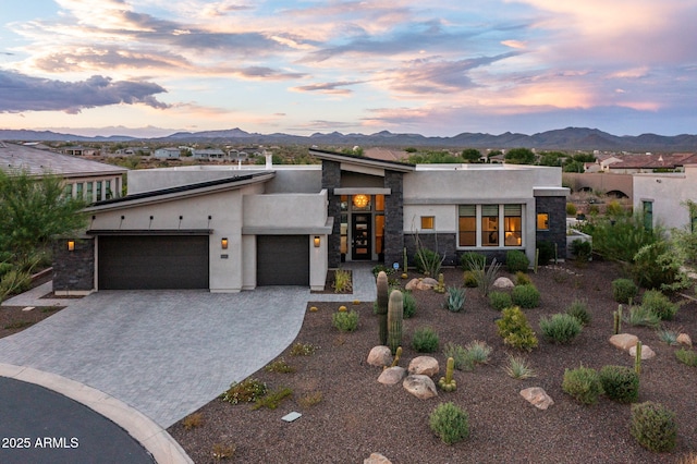 view of front facade with a mountain view and a garage