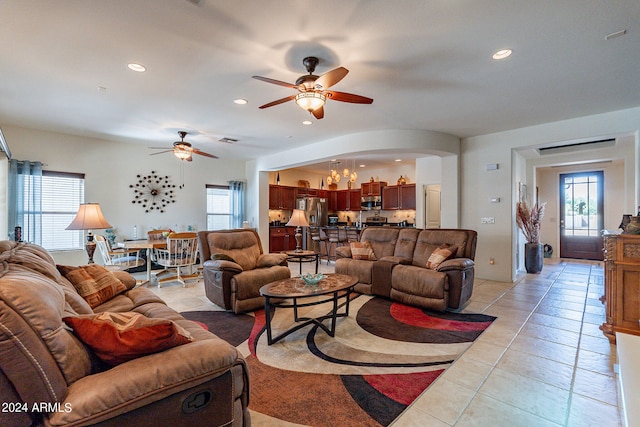 living room with ceiling fan and light tile patterned flooring