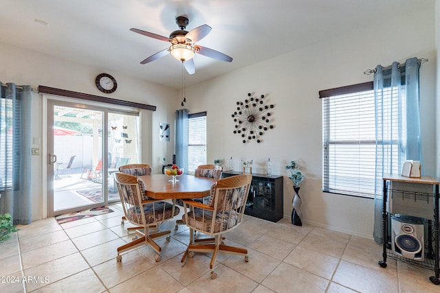 tiled dining space with ceiling fan