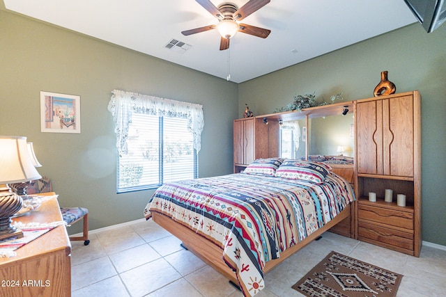 bedroom with ceiling fan and light tile patterned floors