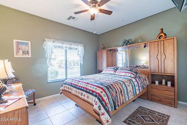 bedroom with ceiling fan and light tile patterned floors