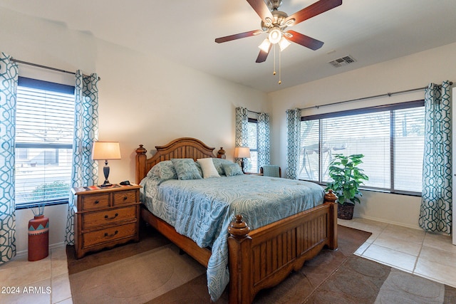 bedroom with ceiling fan and tile patterned flooring