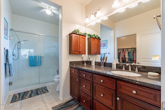 bathroom featuring ceiling fan, toilet, an enclosed shower, tile patterned floors, and vanity