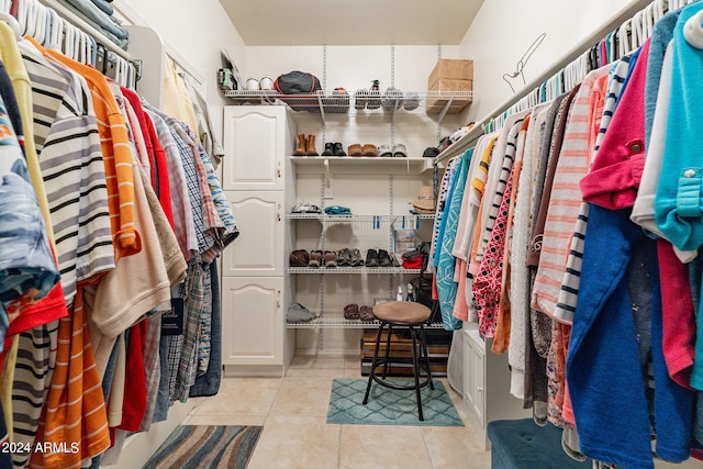 spacious closet featuring light tile patterned flooring