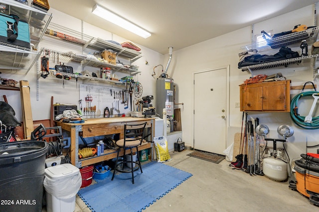 garage featuring a workshop area and water heater