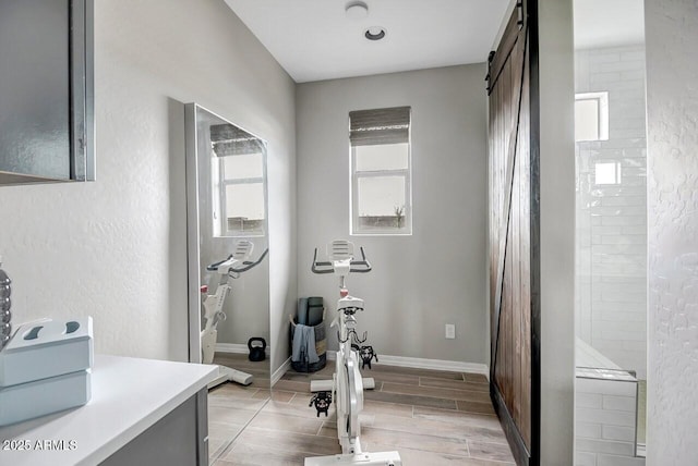 exercise area with a barn door