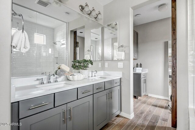 bathroom featuring a shower and vanity