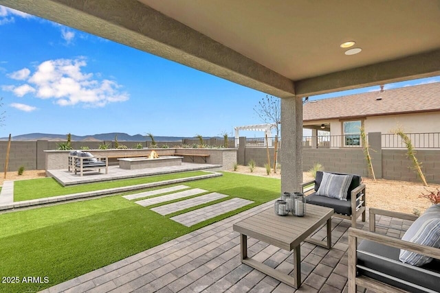 view of patio / terrace featuring a pergola, a mountain view, and an outdoor living space with a fire pit