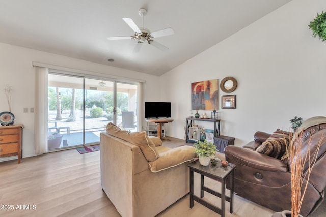 living room featuring ceiling fan, lofted ceiling, and light wood-type flooring