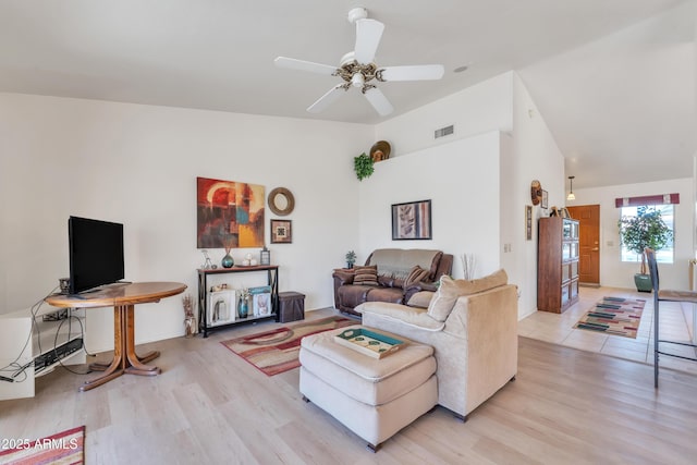 living room featuring ceiling fan, vaulted ceiling, and hardwood / wood-style floors