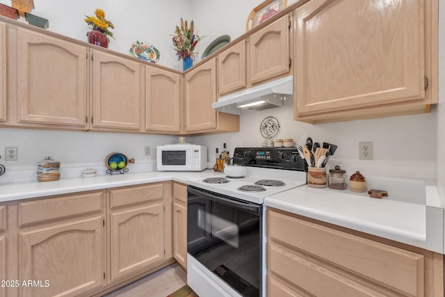 kitchen with electric range oven and light brown cabinetry