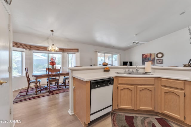 kitchen featuring pendant lighting, sink, dishwasher, a wealth of natural light, and kitchen peninsula