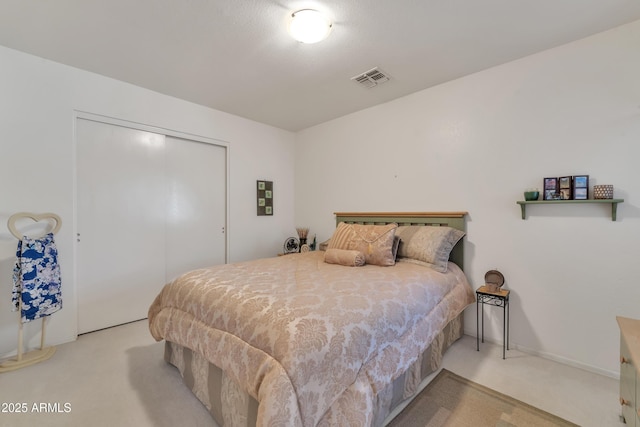 bedroom with light carpet and a closet