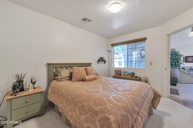 bedroom featuring light colored carpet