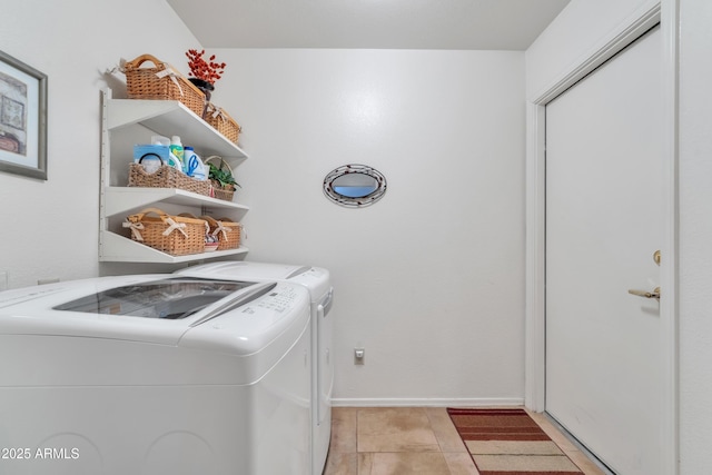 washroom featuring light tile patterned floors and washer and clothes dryer