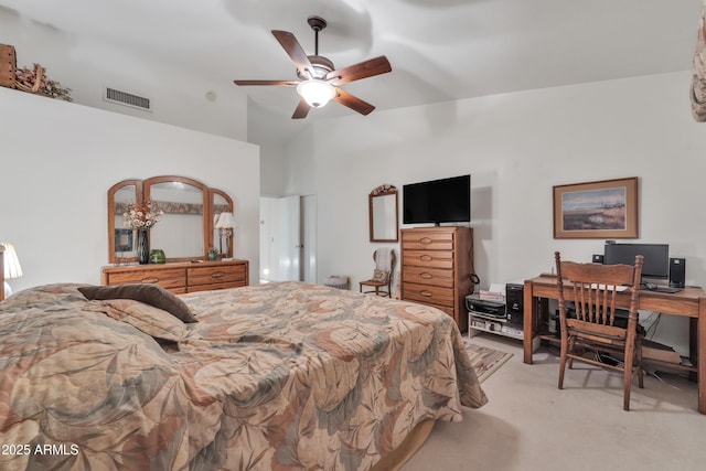 carpeted bedroom with ceiling fan and vaulted ceiling