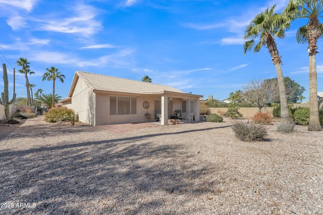 rear view of property featuring a patio area