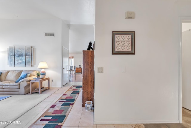 hallway featuring light tile patterned floors