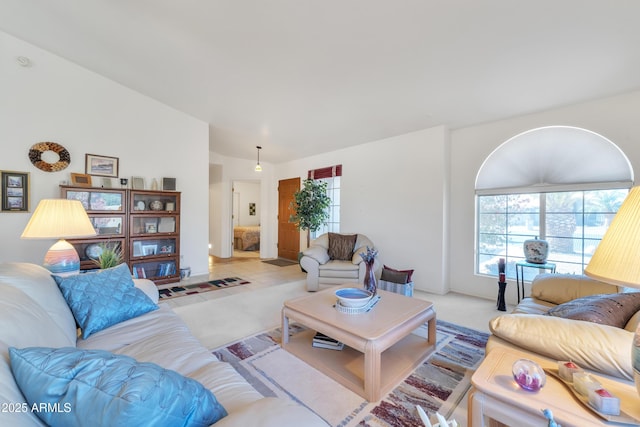 living room with vaulted ceiling and light carpet