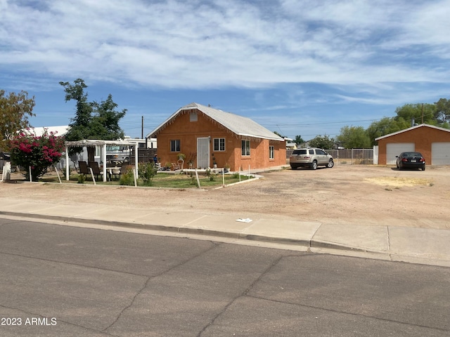 view of front facade featuring an outdoor structure and a garage