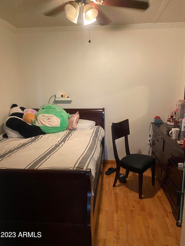 bedroom featuring crown molding, ceiling fan, and light wood-type flooring