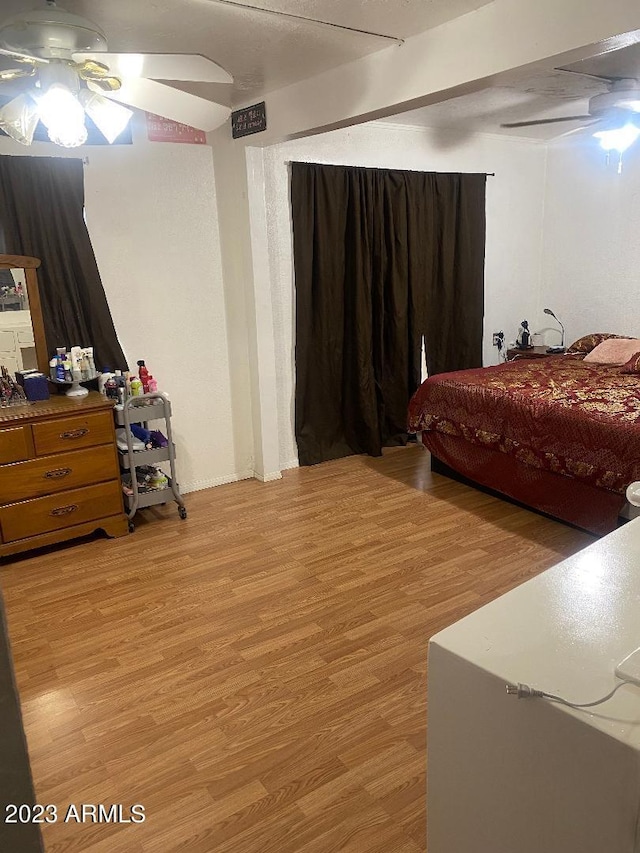 bedroom with ceiling fan and light hardwood / wood-style flooring