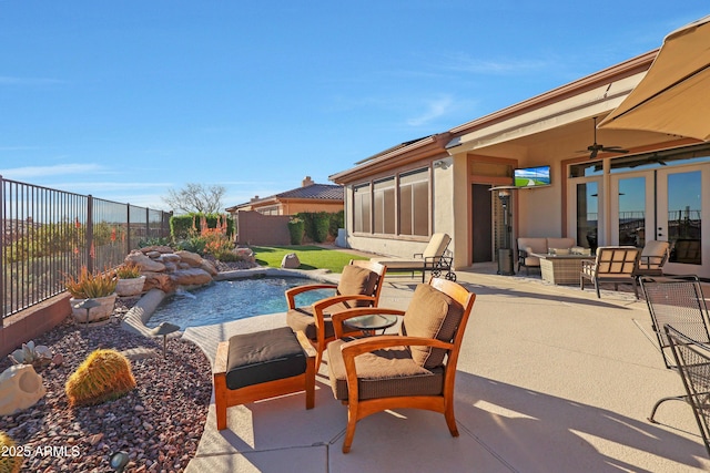 view of patio / terrace featuring an outdoor hangout area, a sunroom, a fenced backyard, and a ceiling fan