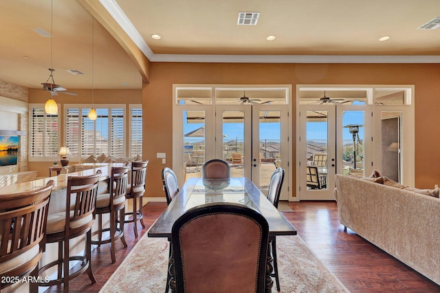 dining space with ornamental molding, french doors, visible vents, and plenty of natural light