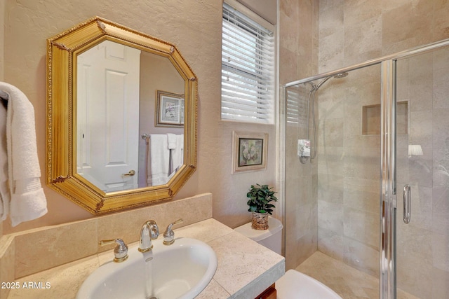 bathroom featuring a stall shower, vanity, and toilet