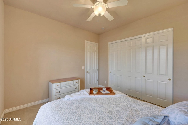 bedroom featuring a ceiling fan, a closet, carpet flooring, and baseboards