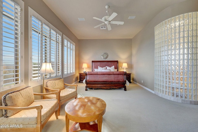 carpeted bedroom with visible vents, baseboards, and a ceiling fan