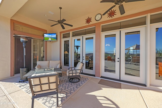 view of patio / terrace with an outdoor living space, a ceiling fan, and french doors