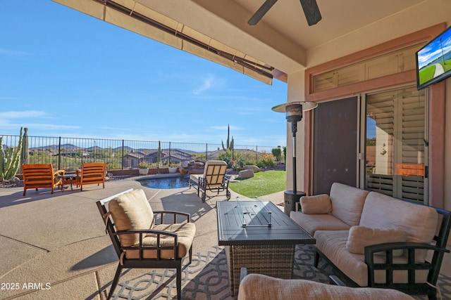 view of patio with an outdoor pool, ceiling fan, fence, and an outdoor hangout area