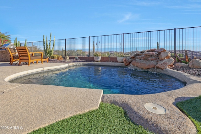 view of swimming pool featuring a patio area, fence, and a fenced in pool