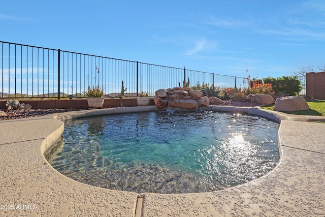 view of pool with a fenced in pool and fence