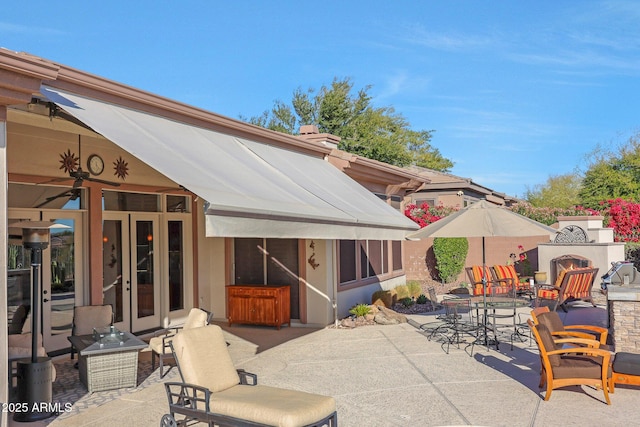 view of patio / terrace featuring a fireplace and outdoor dining space